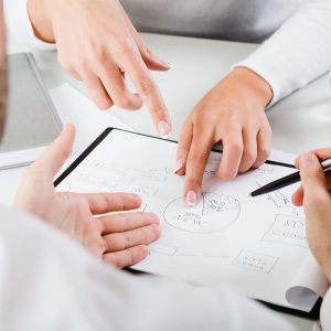 Woman’s hands pointing on the resources of new project